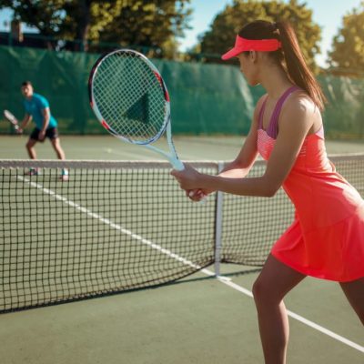 couple-playing-tennis-on-outdoor-court.jpg